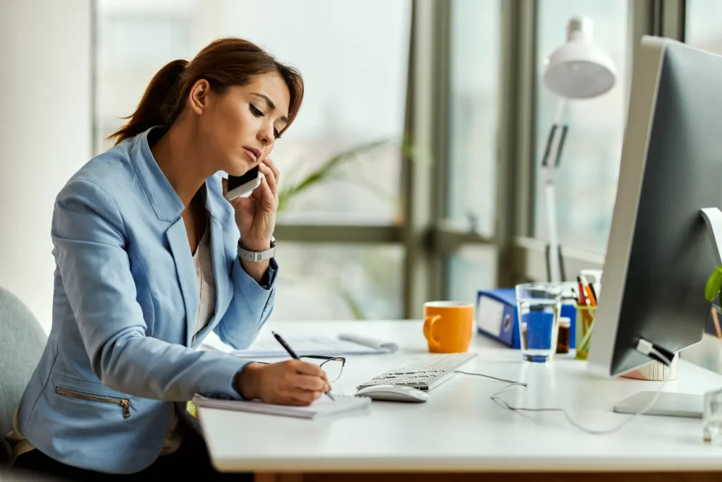 virtual assistant writing on notepad to help solopreneur